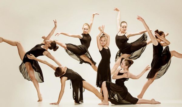 Kvinnor i svarta klänningar dansar elegant